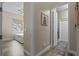 Hallway with an open bedroom and laundry room with hard surface floors at 3400 Rose Mallow Loop, Oviedo, FL 32766