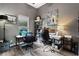 Well-lit home office with two desks, comfortable chairs, and a window view of the pool at 3400 Rose Mallow Loop, Oviedo, FL 32766