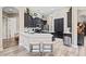 Modern kitchen features dark cabinetry, stainless steel appliances, and a spacious island with bar seating at 3400 Rose Mallow Loop, Oviedo, FL 32766