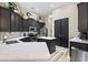 Bright kitchen featuring stainless steel appliances, island, light countertops, and dark cabinets at 3400 Rose Mallow Loop, Oviedo, FL 32766