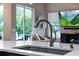 Modern kitchen sink with stainless steel faucet and view of the backyard at 3400 Rose Mallow Loop, Oviedo, FL 32766