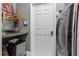 Functional laundry room with counter space, small refrigerator, and modern washer-dryer at 3400 Rose Mallow Loop, Oviedo, FL 32766