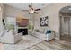 Cozy living room with a plush sofa, armchairs, modern decor, and a ceiling fan at 3400 Rose Mallow Loop, Oviedo, FL 32766
