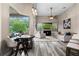 Bright living room featuring large windows, modern lighting, a dining table, and comfortable seating at 3400 Rose Mallow Loop, Oviedo, FL 32766