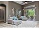 Comfortable living room featuring plush seating, arched mirrors, and sliding glass doors to the lanai at 3400 Rose Mallow Loop, Oviedo, FL 32766