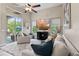 Bright living room with ceiling fan, plush rug, and sliding glass doors to the outdoor area at 3400 Rose Mallow Loop, Oviedo, FL 32766
