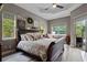 Spacious bedroom with a large sleigh bed, multiple windows, and access to an outdoor space at 3400 Rose Mallow Loop, Oviedo, FL 32766