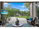Covered patio with TV, comfortable seating, view of landscaped backyard, and brick paver patio at 3400 Rose Mallow Loop, Oviedo, FL 32766