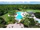 Community pool area featuring lounge chairs, mature trees, and a spacious deck for relaxation at 3400 Rose Mallow Loop, Oviedo, FL 32766