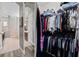 Organized walk-in closet featuring wire shelving with clothing on hangers and folded on shelves at 3400 Rose Mallow Loop, Oviedo, FL 32766
