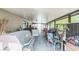 Enclosed porch filled with various furniture, a grill, and household items at 3711 Shady Grove Cir, Orlando, FL 32810