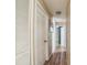 Hallway with wood floors, a ceiling light, and multiple doors leading to other rooms at 3711 Shady Grove Cir, Orlando, FL 32810