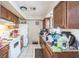 Functional kitchen with white appliances, wooden cabinets, and a tile floor at 3711 Shady Grove Cir, Orlando, FL 32810