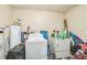 Laundry room area showing a washing machine and water heater amongst stored items at 3711 Shady Grove Cir, Orlando, FL 32810