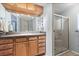 Bathroom showcasing wood cabinets and a shower stall with sliding glass doors at 38 Da Rosa Ave, Debary, FL 32713