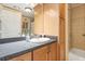 Well-lit bathroom featuring a vanity with wood cabinets, shower with tile surround, and ample storage at 38 Da Rosa Ave, Debary, FL 32713