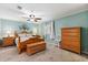Charming bedroom with wood furniture, ceiling fan, and a decorative tree of life wall decoration at 38 Da Rosa Ave, Debary, FL 32713