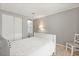 Comfortable bedroom with a white bed, closet, and view into an adjoining space at 38 Da Rosa Ave, Debary, FL 32713