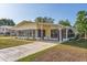 Charming single-story home featuring a covered carport and enclosed sunroom at 38 Da Rosa Ave, Debary, FL 32713