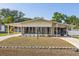 Inviting single-story home showcasing a well-maintained lawn and long carport at 38 Da Rosa Ave, Debary, FL 32713