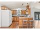 Spacious kitchen with wooden cabinetry, an island with seating, and modern appliances at 38 Da Rosa Ave, Debary, FL 32713