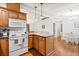 Partially opened kitchen showing stove, counter space, cabinets, and breakfast nook at 38 Da Rosa Ave, Debary, FL 32713