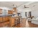 Well-designed kitchen featuring wooden cabinets, a breakfast bar, and an open layout to the living area at 38 Da Rosa Ave, Debary, FL 32713