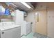 Functional laundry room equipped with a washer, dryer, storage cabinet, and a utility sink for added convenience at 38 Da Rosa Ave, Debary, FL 32713