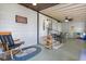 Covered patio with rocking chair, outdoor dining set, and ceiling fan at 38 Da Rosa Ave, Debary, FL 32713