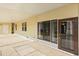 Spacious covered patio with concrete flooring and access to the home through a glass-paneled door at 38 Da Rosa Ave, Debary, FL 32713