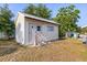 Exterior view of a well-maintained shed with neutral siding, a metal roof, and a small ramp for easy access at 38 Da Rosa Ave, Debary, FL 32713