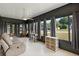 Bright and airy sunroom featuring neutral paint, tile floors, and multiple windows with backyard views at 38 Da Rosa Ave, Debary, FL 32713