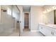 Bathroom featuring a glass enclosed shower, double vanity, and modern finishes at 4204 Barbuda Ln, Kissimmee, FL 34758