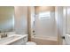 Well-lit bathroom featuring a shower-tub combo with white subway tile and a large mirror at 4204 Barbuda Ln, Kissimmee, FL 34758