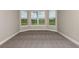 Bright bedroom with plush carpet, a bay window, and peaceful views at 4204 Barbuda Ln, Kissimmee, FL 34758