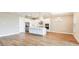Open-concept kitchen with white cabinetry, stainless steel appliances, island, and a spacious dining area at 4204 Barbuda Ln, Kissimmee, FL 34758