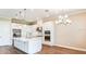 Bright and airy kitchen with white cabinets, stainless steel appliances, center island, and pendant lighting at 4204 Barbuda Ln, Kissimmee, FL 34758