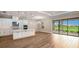 Open floorplan with kitchen, center island, stainless steel appliances, and a view of the lanai at 4204 Barbuda Ln, Kissimmee, FL 34758