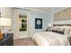 Charming bedroom featuring soft blue walls, stylish decor, and a comfortable, inviting bed at 4210 Barbuda Ln, Kissimmee, FL 34758