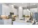 Modern kitchen with white cabinets, stainless steel appliances, and a spacious center island at 4210 Barbuda Ln, Kissimmee, FL 34758