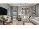 A cozy living room featuring stylish decor, a gray color scheme, and a dedicated workspace at 4210 Barbuda Ln, Kissimmee, FL 34758