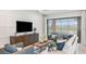 This modern living room features stylish furnishings, wood accents, and sliding glass doors at 4210 Barbuda Ln, Kissimmee, FL 34758