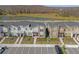 Aerial view of contemporary townhouses with lush landscaping, driveways, and ample parking at 4375 Scene Ln, Kissimmee, FL 34746