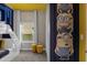 Bedroom with a bunk bed, cartoon wall decor, yellow stools and a window at 4375 Scene Ln, Kissimmee, FL 34746