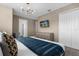 Cozy bedroom featuring a dresser, television, and ensuite bathroom at 4375 Scene Ln, Kissimmee, FL 34746