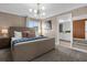 Inviting bedroom featuring a large window, stylish light fixture, and ensuite bathroom at 4375 Scene Ln, Kissimmee, FL 34746