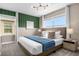 Bright bedroom with large windows, stylish lighting, and neutral tones at 4375 Scene Ln, Kissimmee, FL 34746