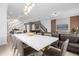 Open dining area with a white table, comfortable chairs, and stylish lighting at 4375 Scene Ln, Kissimmee, FL 34746
