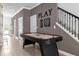 Hallway with an air hockey table, stairway, and playful decor for entertainment at 4375 Scene Ln, Kissimmee, FL 34746