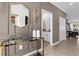 Elegant hallway featuring a stylish gold mirror, glass console table, and a peek into the powder room at 4375 Scene Ln, Kissimmee, FL 34746